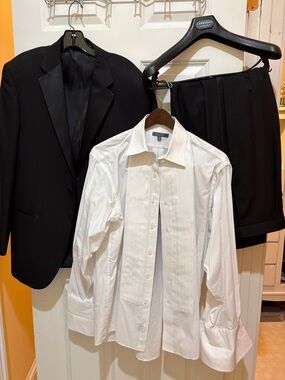 Men's  Black Tuxedo with satin lapel and black satin leg stripe.